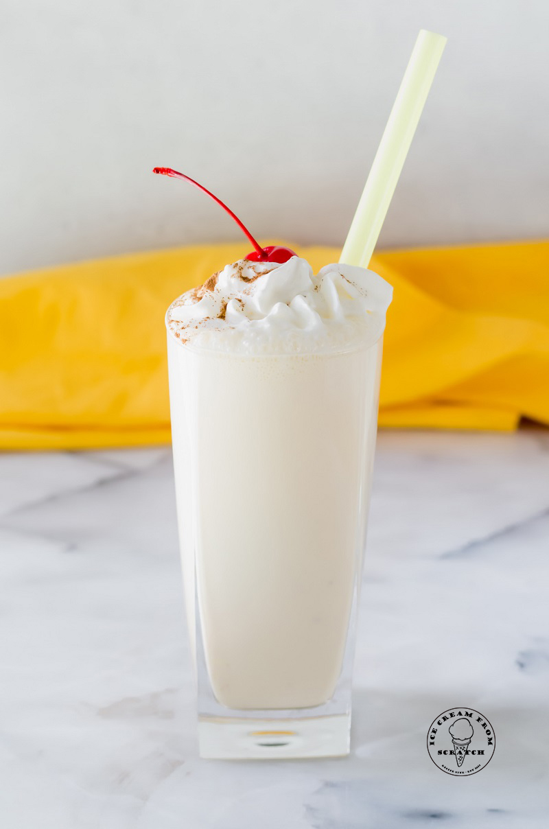 banana milkshake with whipped cream and a cherry on top