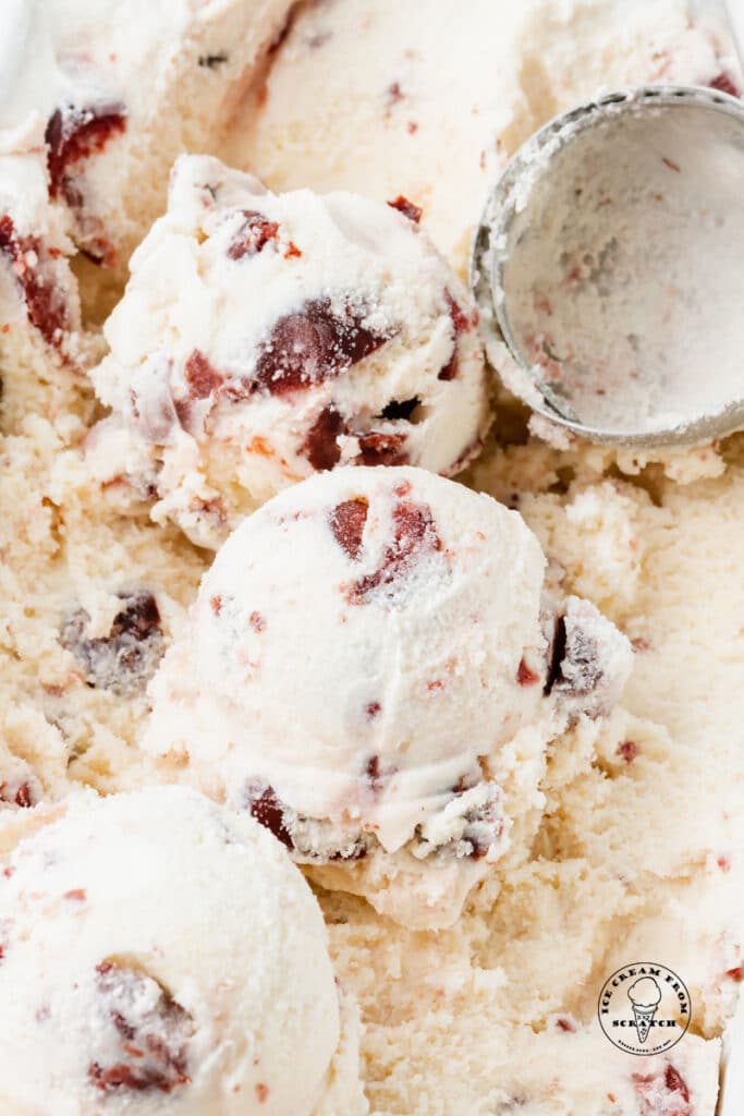 close up of scoops of cherry vanilla ice cream in a pan