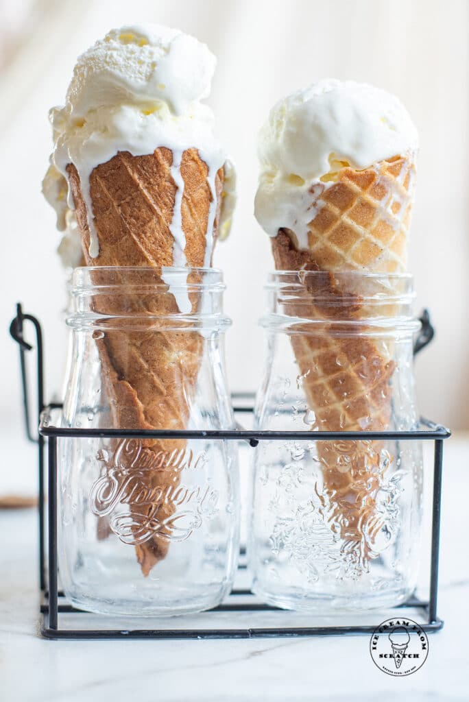 two ice cream cones with a scoop of coconut sorbet on top