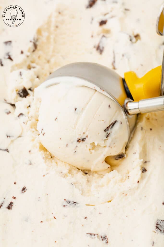 java chip ice cream being scooped with a vintage style metal ice cream scoop.