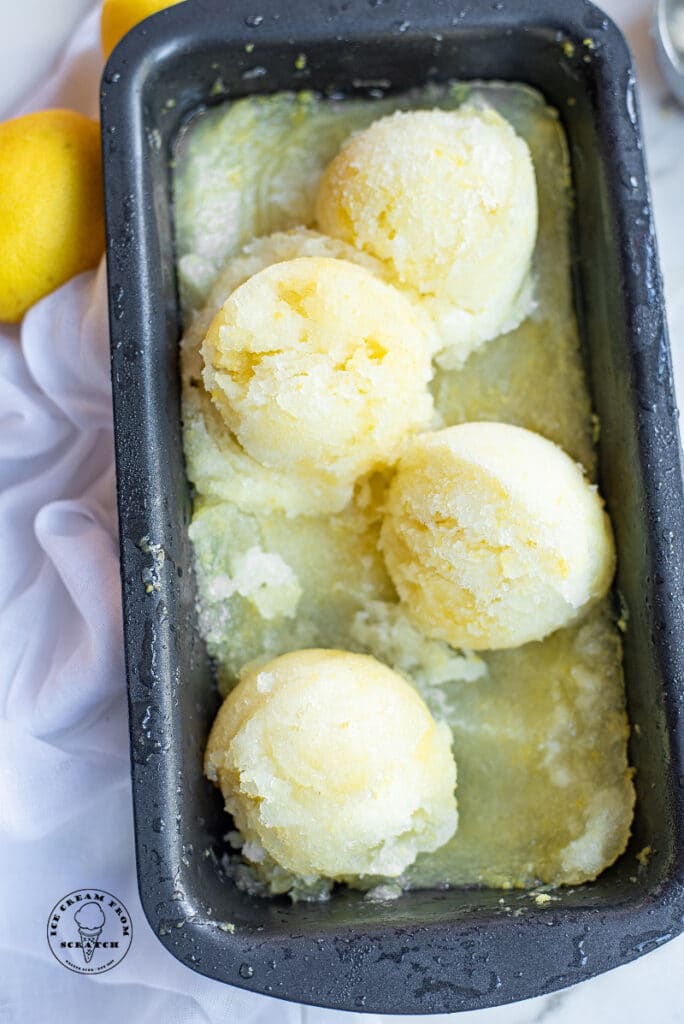scoops of lemon sorbet in a metal pan
