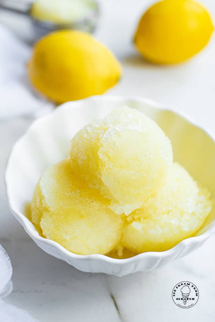 three scoops of lemon sorbet in a white bowl