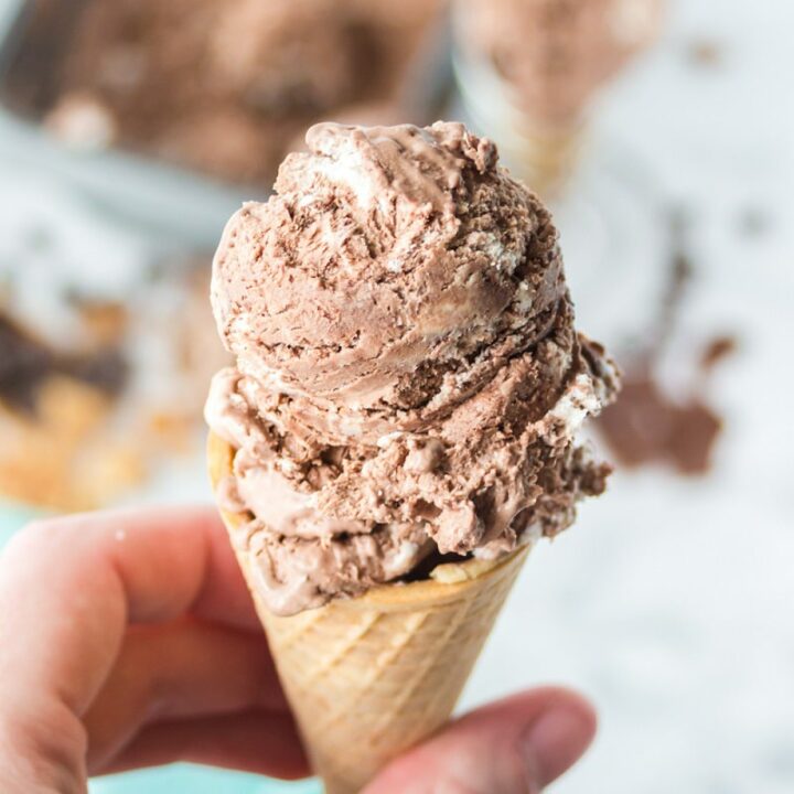a hand holding a sugar cone of no churn chocolate ice cream.