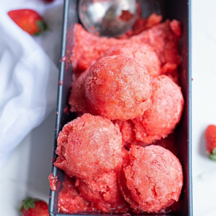 scoops of strawberry sorbet in a metal loaf pan