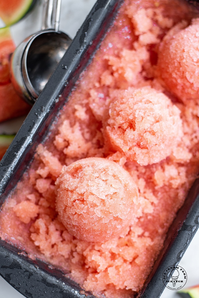 scoops of watermelon sorbet in a metal pan