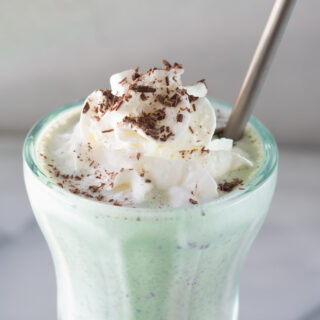 close up of the top of a mint chocolate chip milkshake
