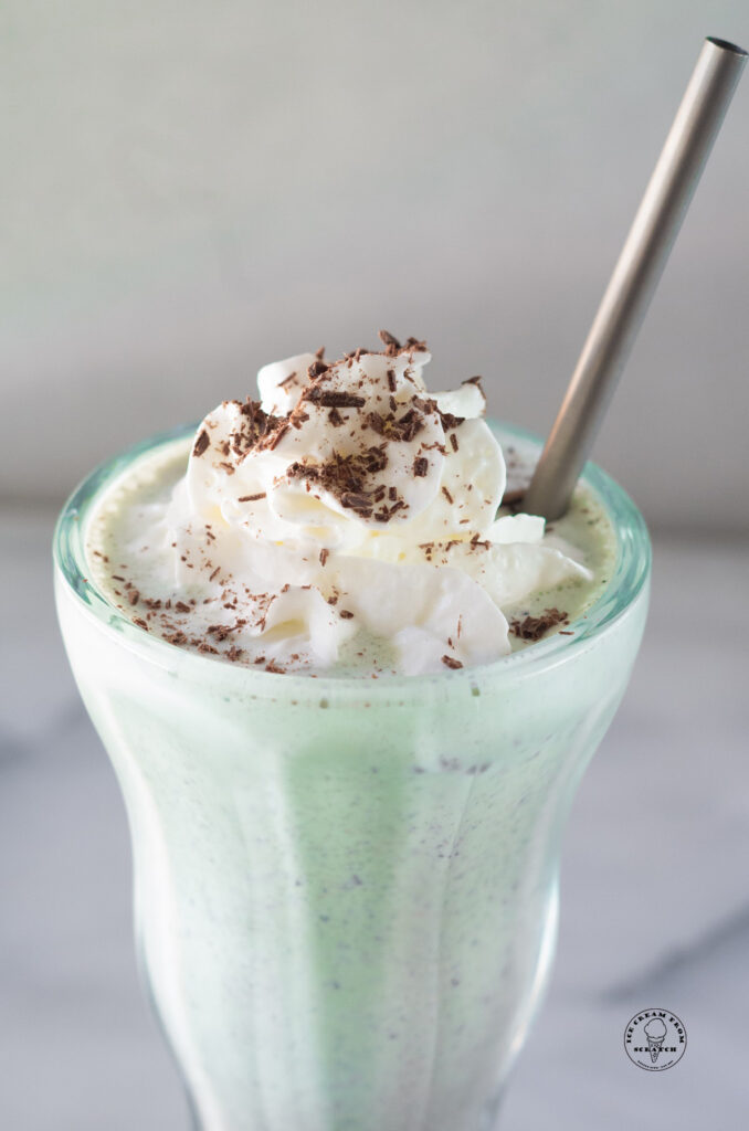 close up of the top of a mint chocolate chip milkshake
