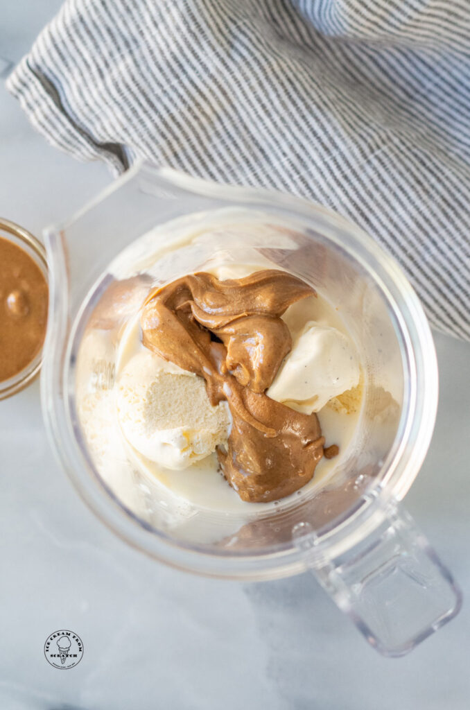 peanut butter and vanilla ice cream in a blender jar