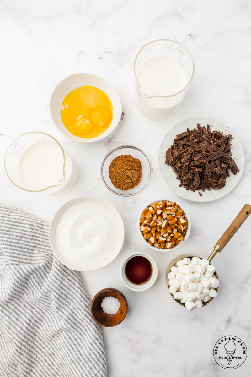 Ingredients for homemade rocky road ice cream, measured and set out on a marble counter