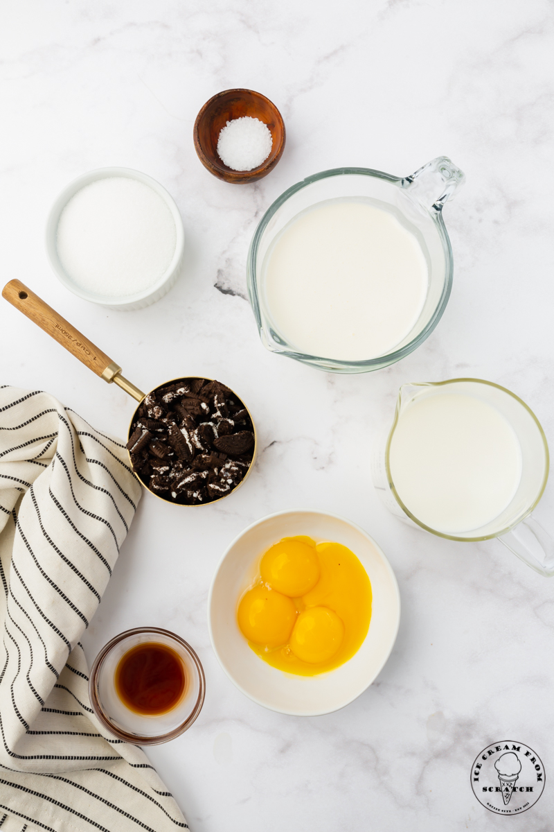 overhead view of a counter filled with bowls of ingredients for making homemade oreo ice cream