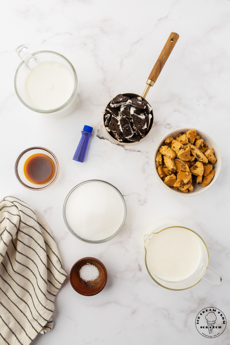 The ingredients for easy cookie monster ice cream measured out into separate bowls and set on a marble counter, viewed from above