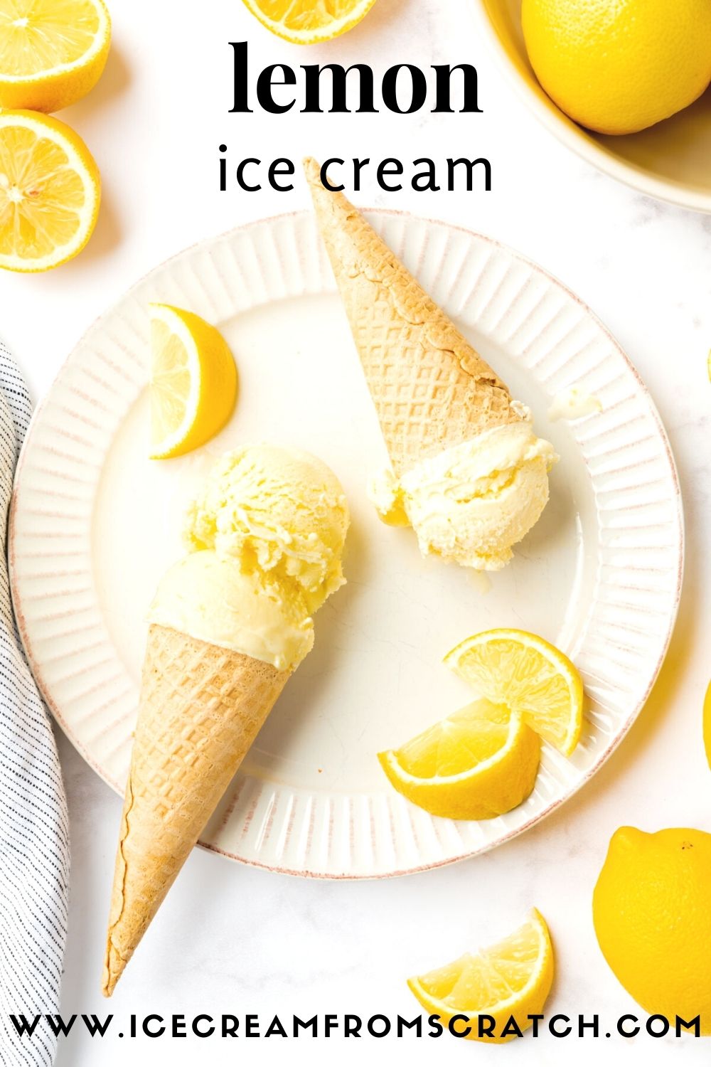 a white fluted plate holding two sugar cones of homemade lemon ice cream, garnished with lemon wedges. Viewed from above.