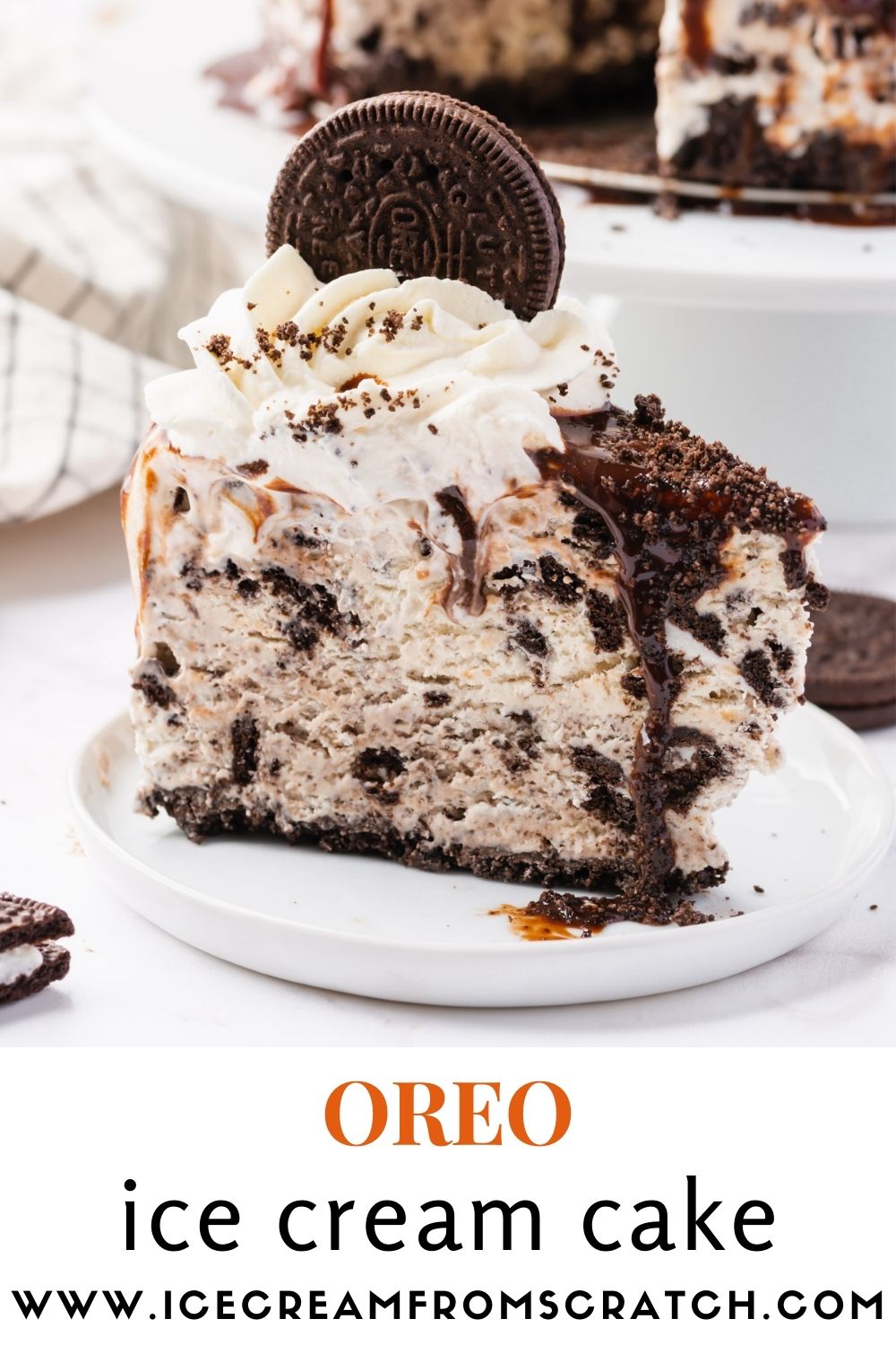 a slice of scratch made oreo ice cream cake, viewed from the side, on a small white plate.