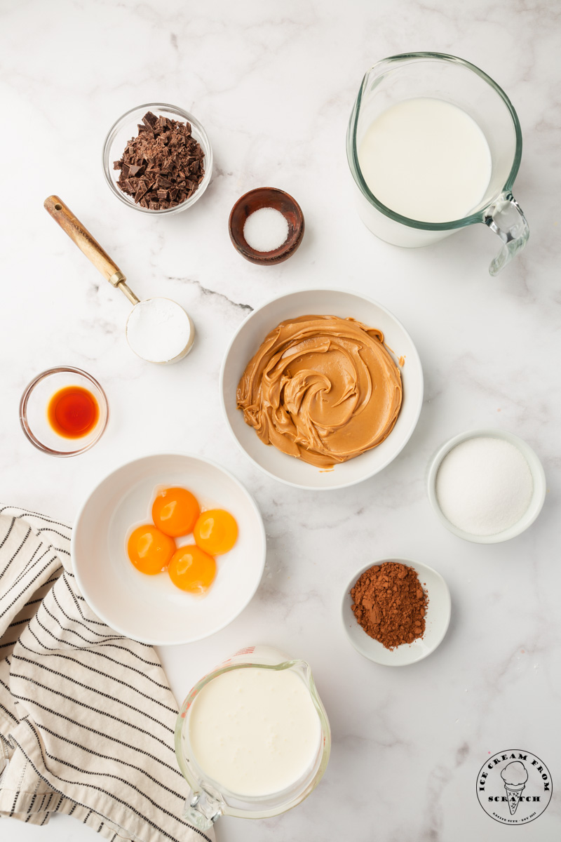 The ingredients needed to make chocolate peanut butter ice cream from scratch, viewed from above.