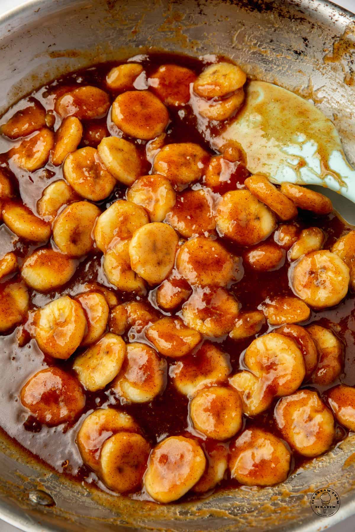 caramelized banans in a stainless steel saute pan, closeup view.