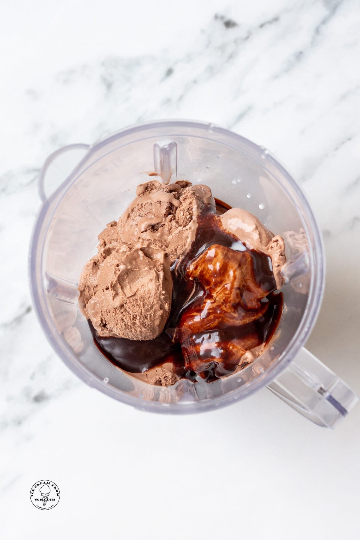 the ingredients for chocolate milkshakes in a blender jar, viewed from above