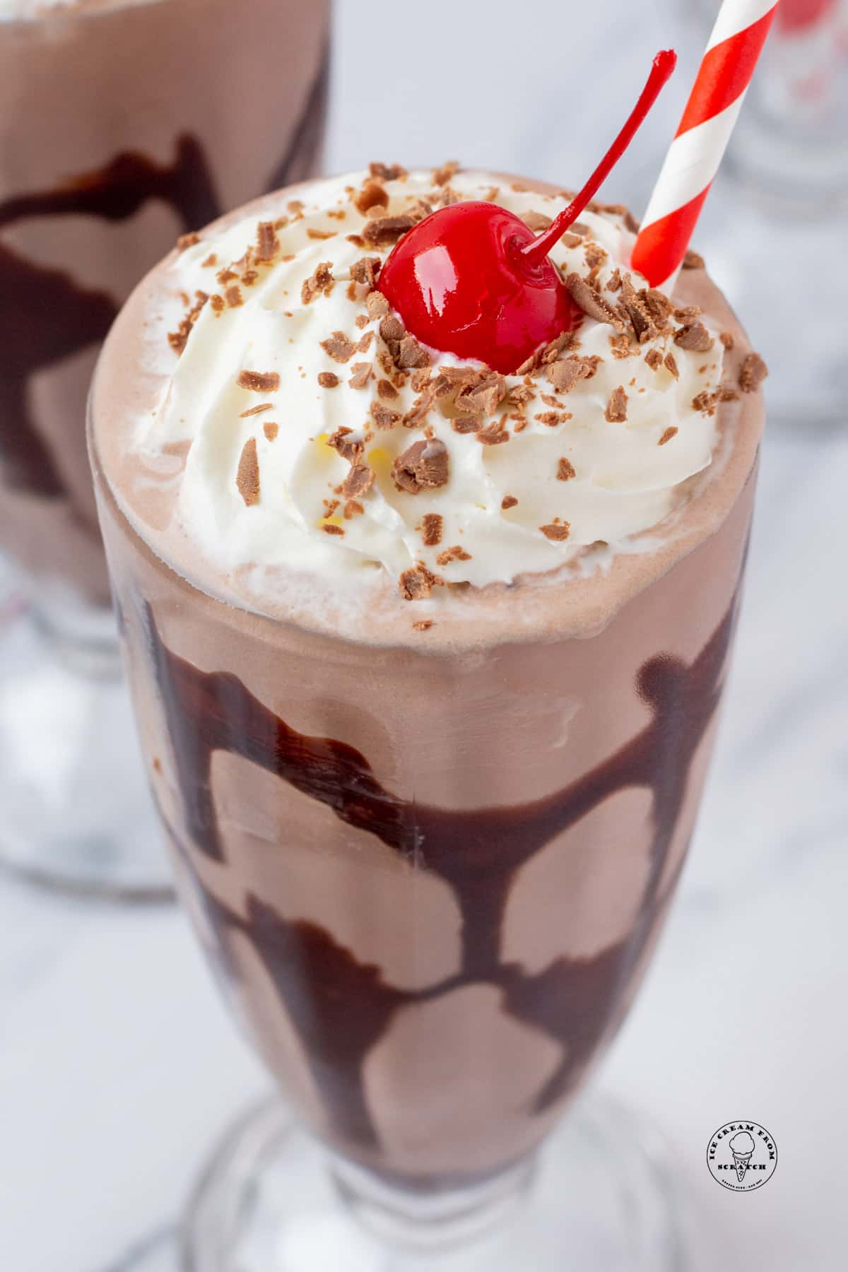 closeup view of a homemade chocolate milkshake topped with a cherry