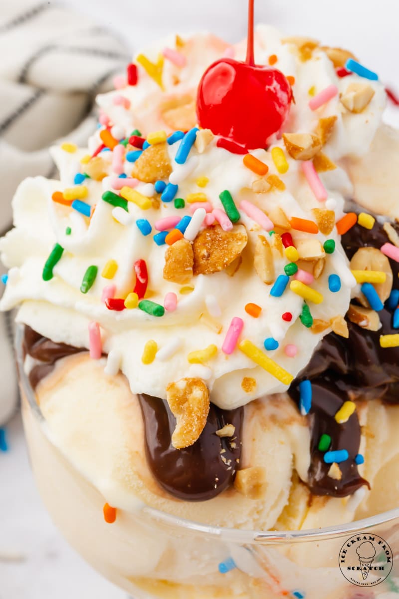 closeup view of a classic hot fudge sundae with a cherry on top.