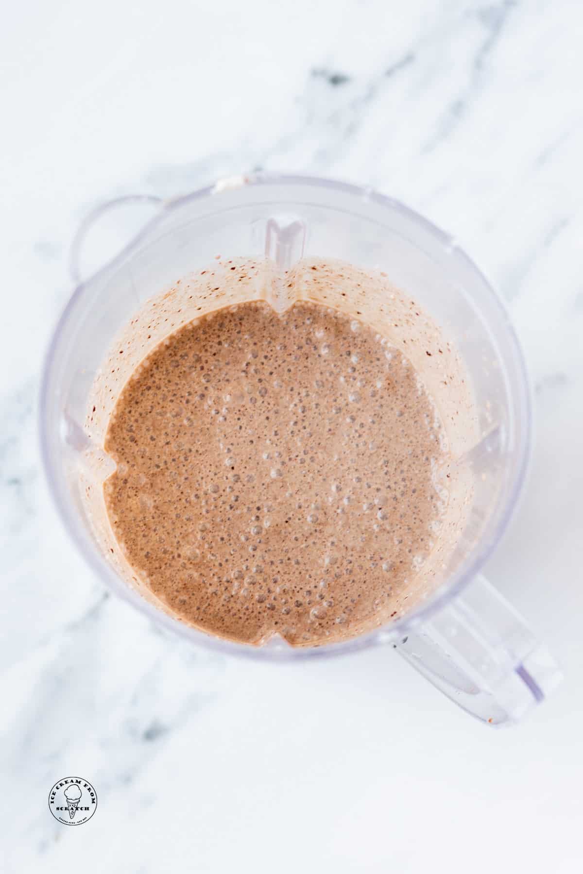 a blended oreo milkshake in the blender, viewed from above.