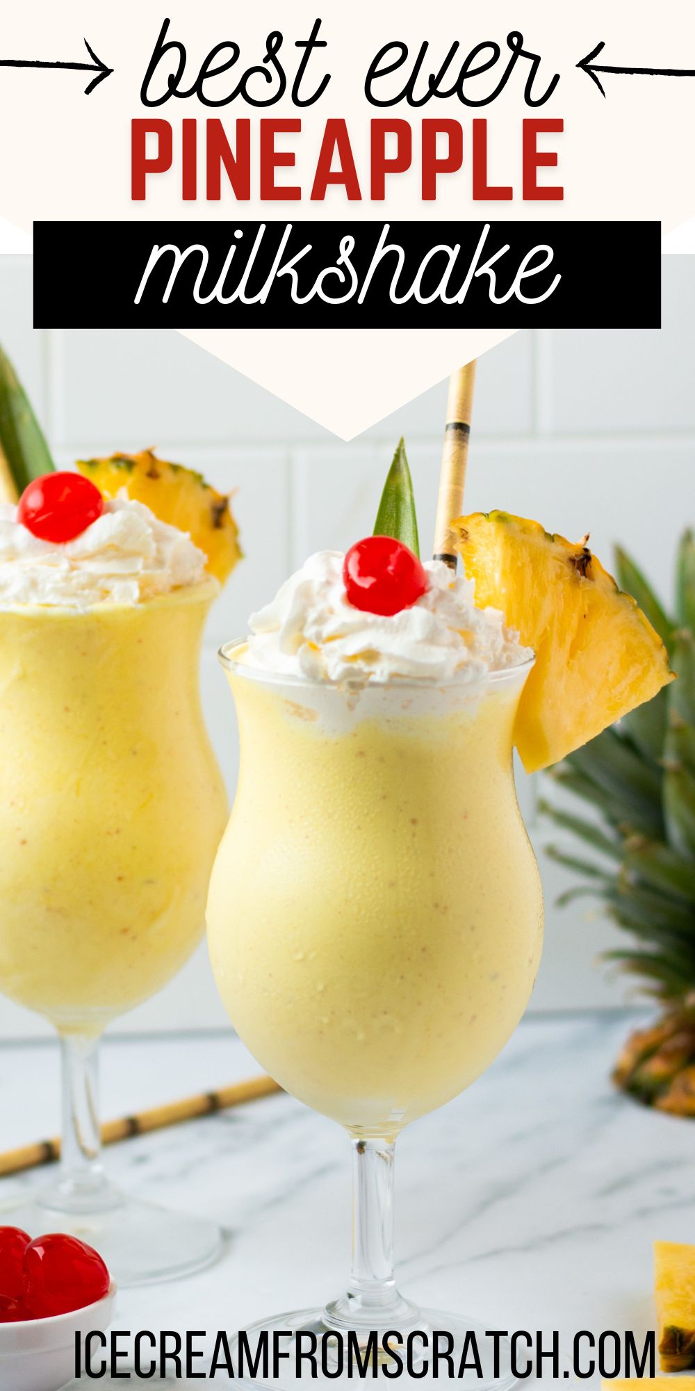 Two hurricane glasses filled with bright pineapple milkshake, topped with whipped cream, cherries, and pineapple wedges. Text at top of image says "best ever pineapple milkshake" in varied fonts