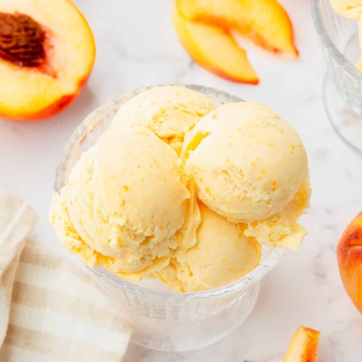 scoops of peaches and cream ice cream in a bowl