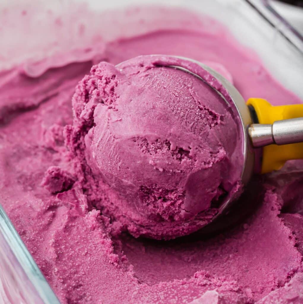 close up of a scoop of black raspberry ice cream