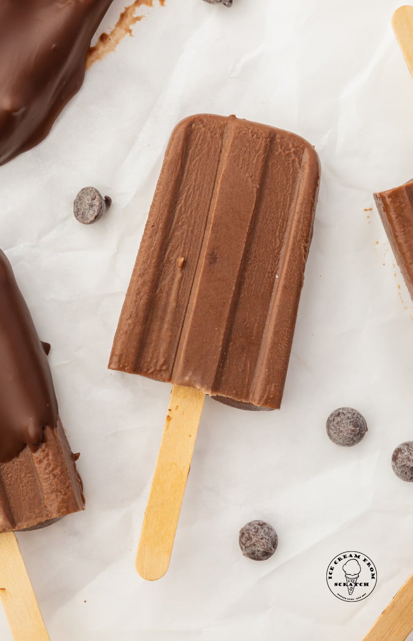 a homemade fudgesicle with chocolate chips near it.