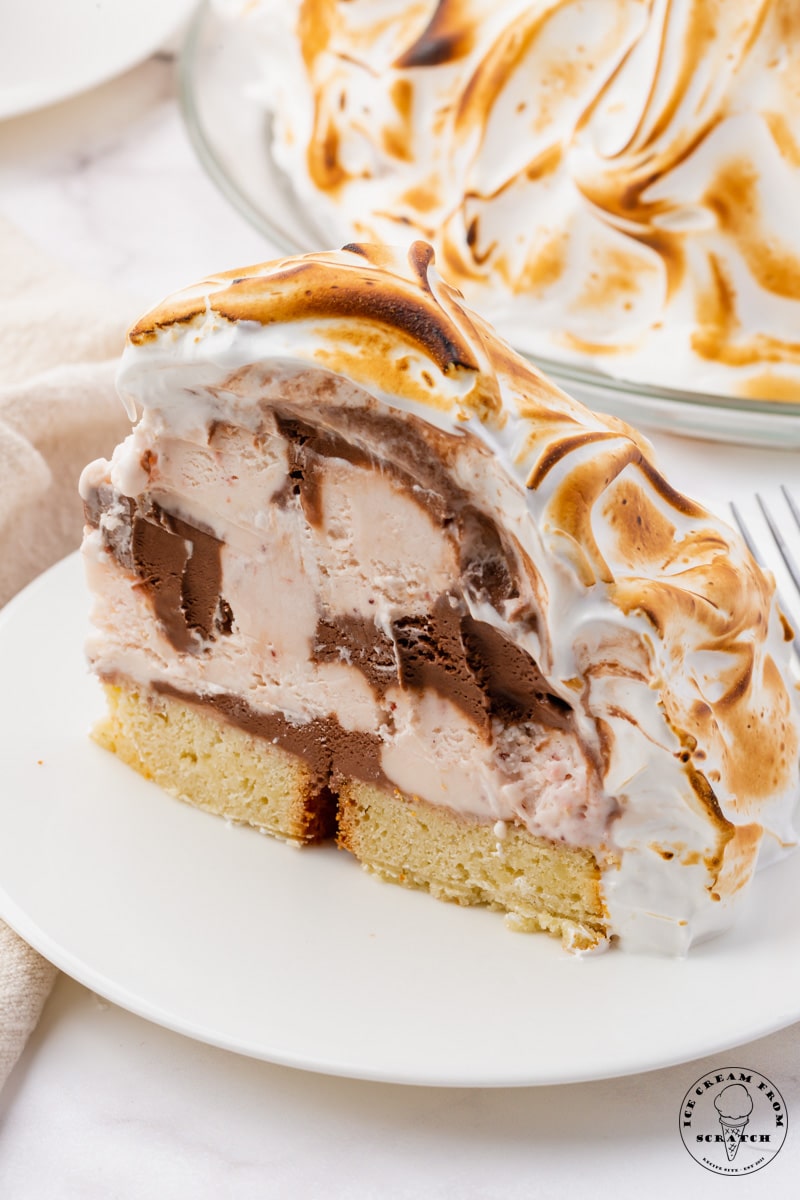 a slice of baked alaska, which is cake, topped with ice cream, then topped with toasted meringue.