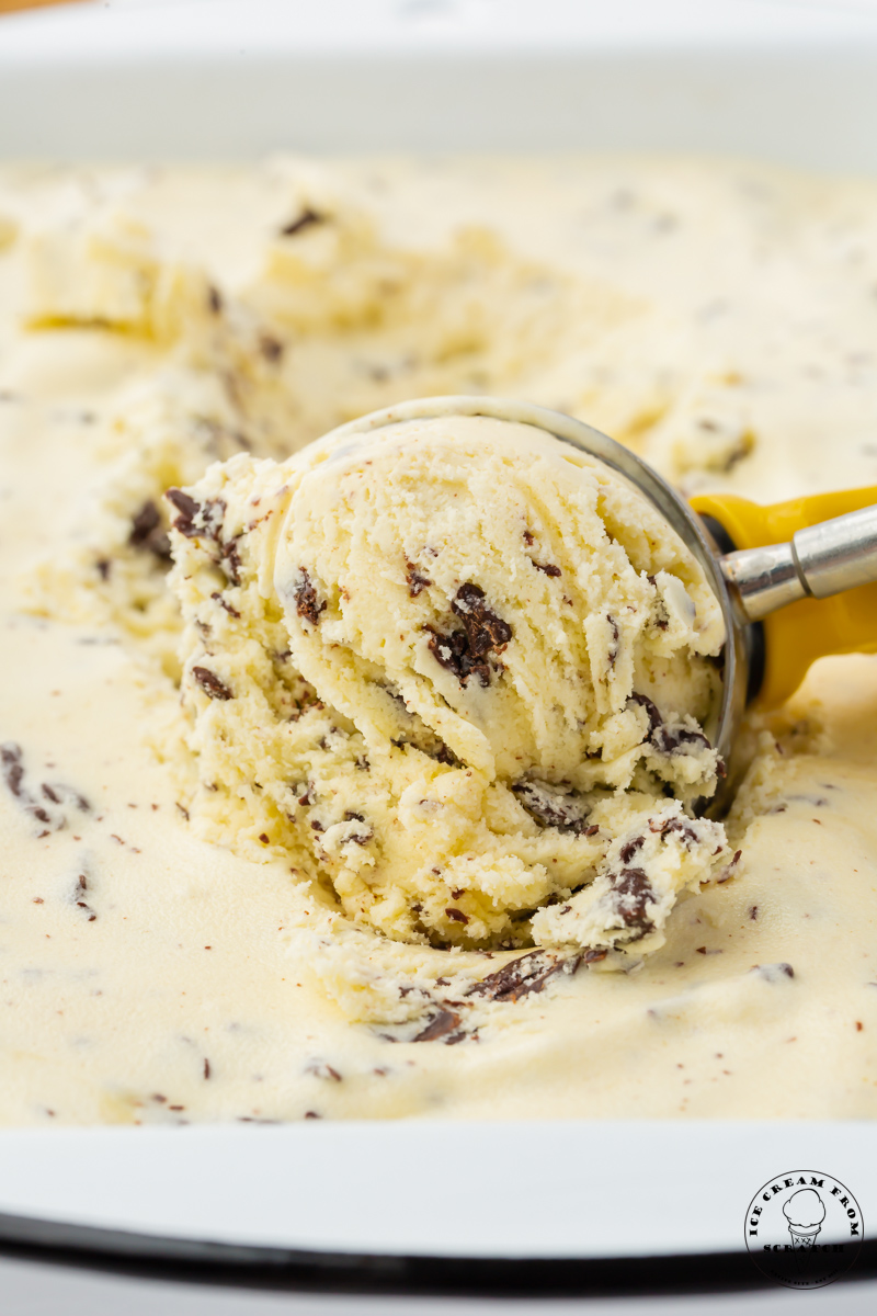 stracciatella ice cream being scooped, close up image.