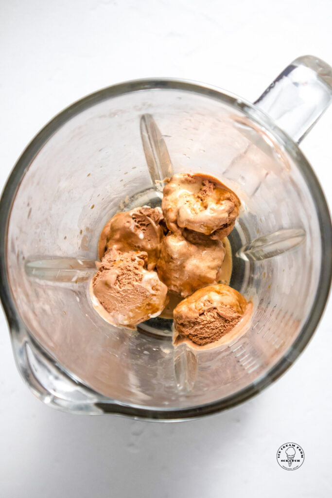 Coffee ice cream in a blender, viewed from above.