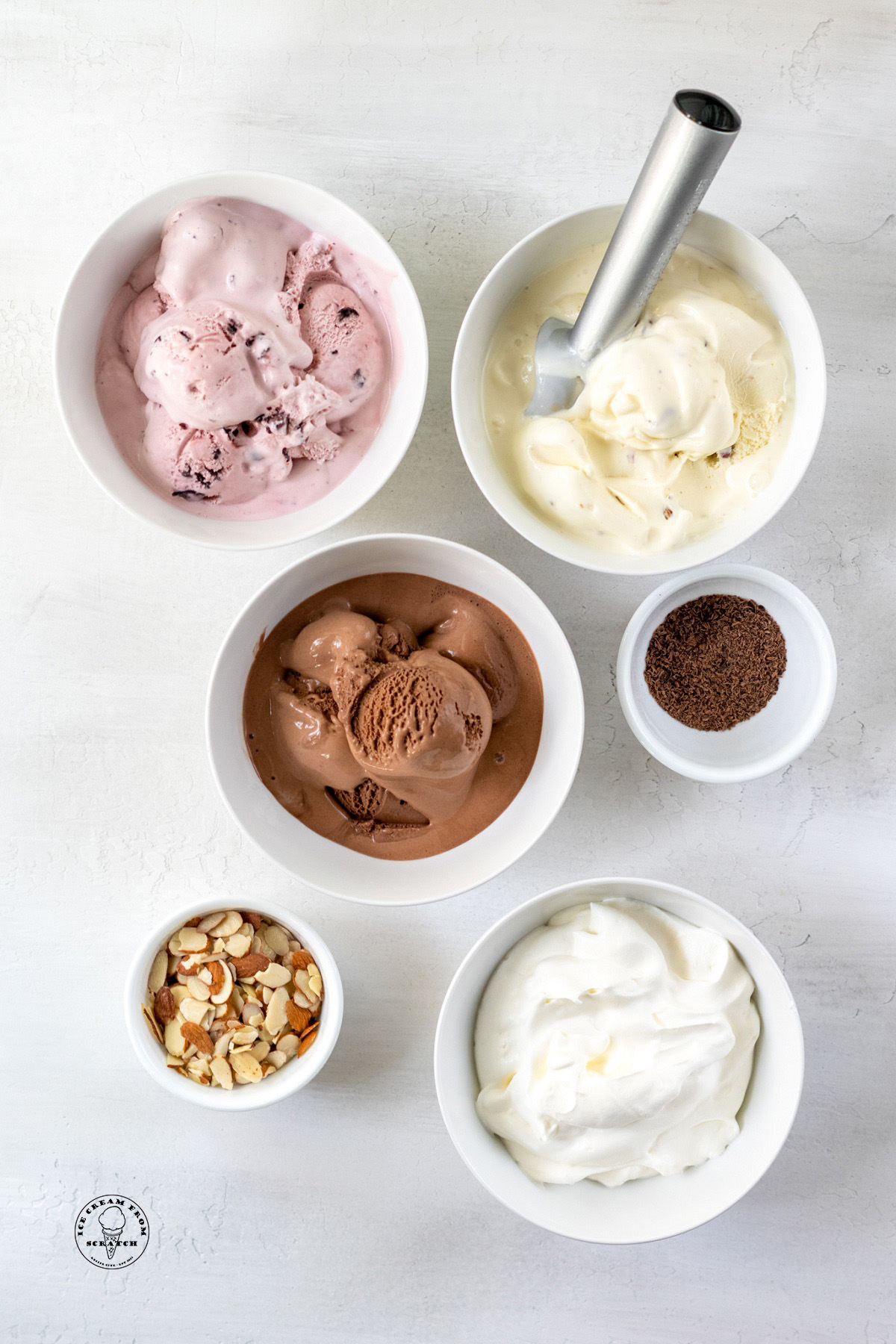 The ingredients needed to make spumoni, including softened ice cream, slivered almonds, and whipped cream.