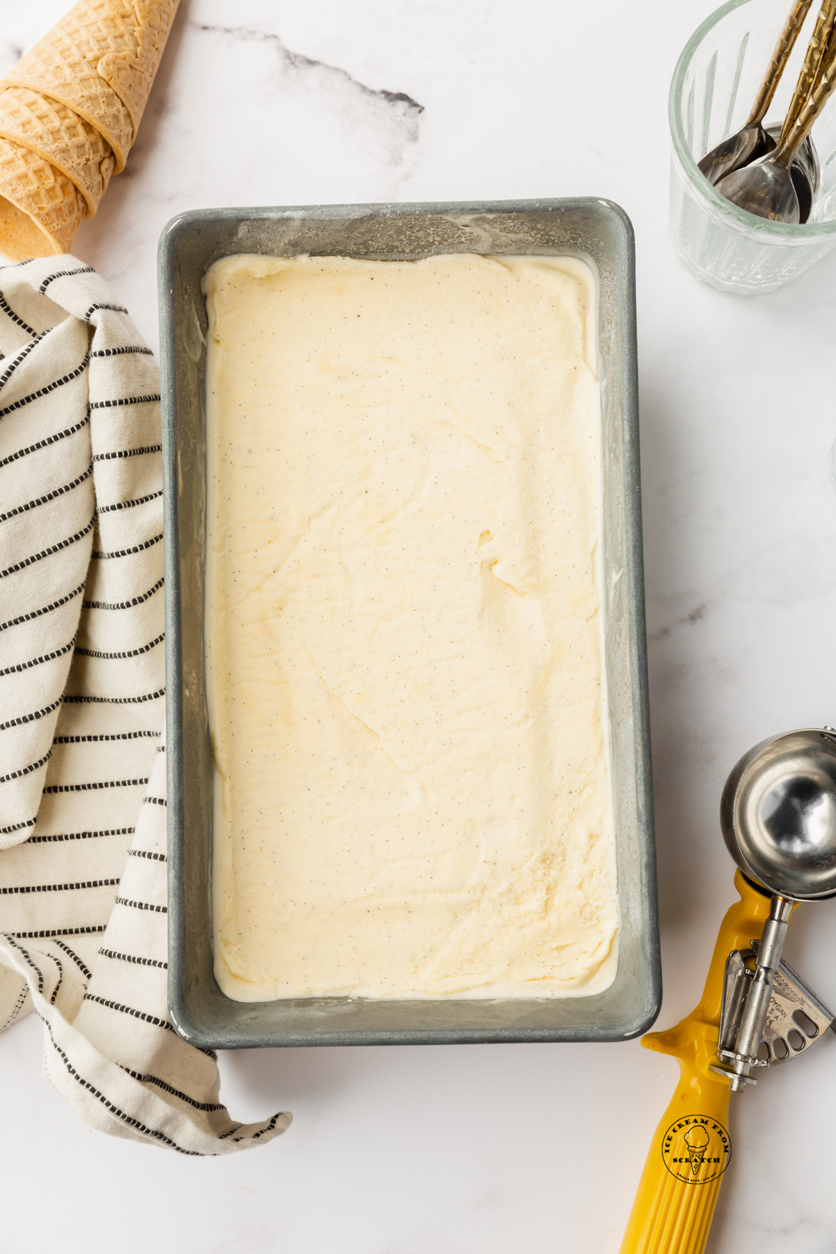 creamy vanilla custard ice cream in a metal loaf pan.