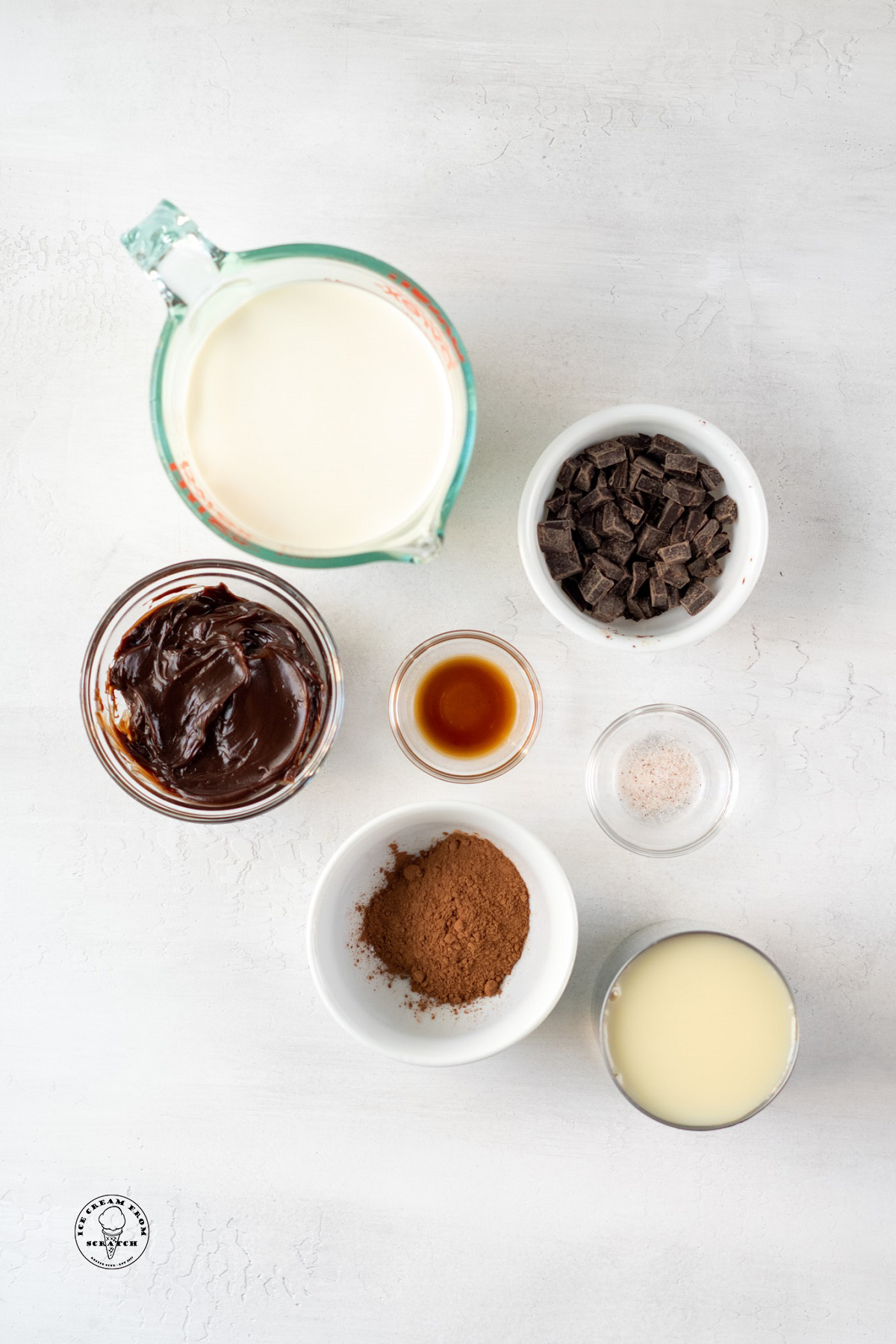The ingredients for no churn death by chocolate ice cream, measured into individual bowls and arranged on a counter.