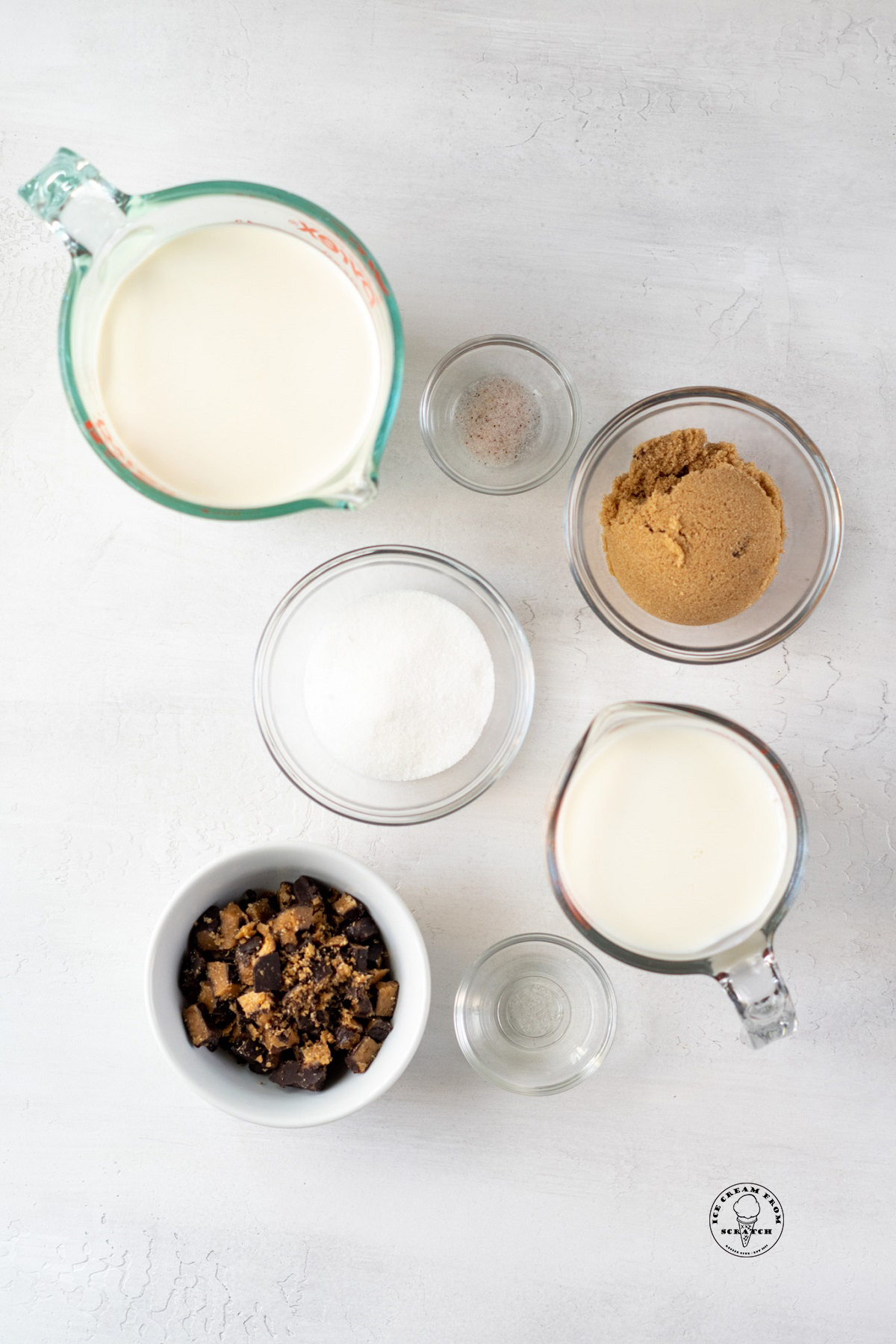 The ingredients needed to make homemade butter brickle ice cream, including cream, milk, brown sugar, and toffee pieces.