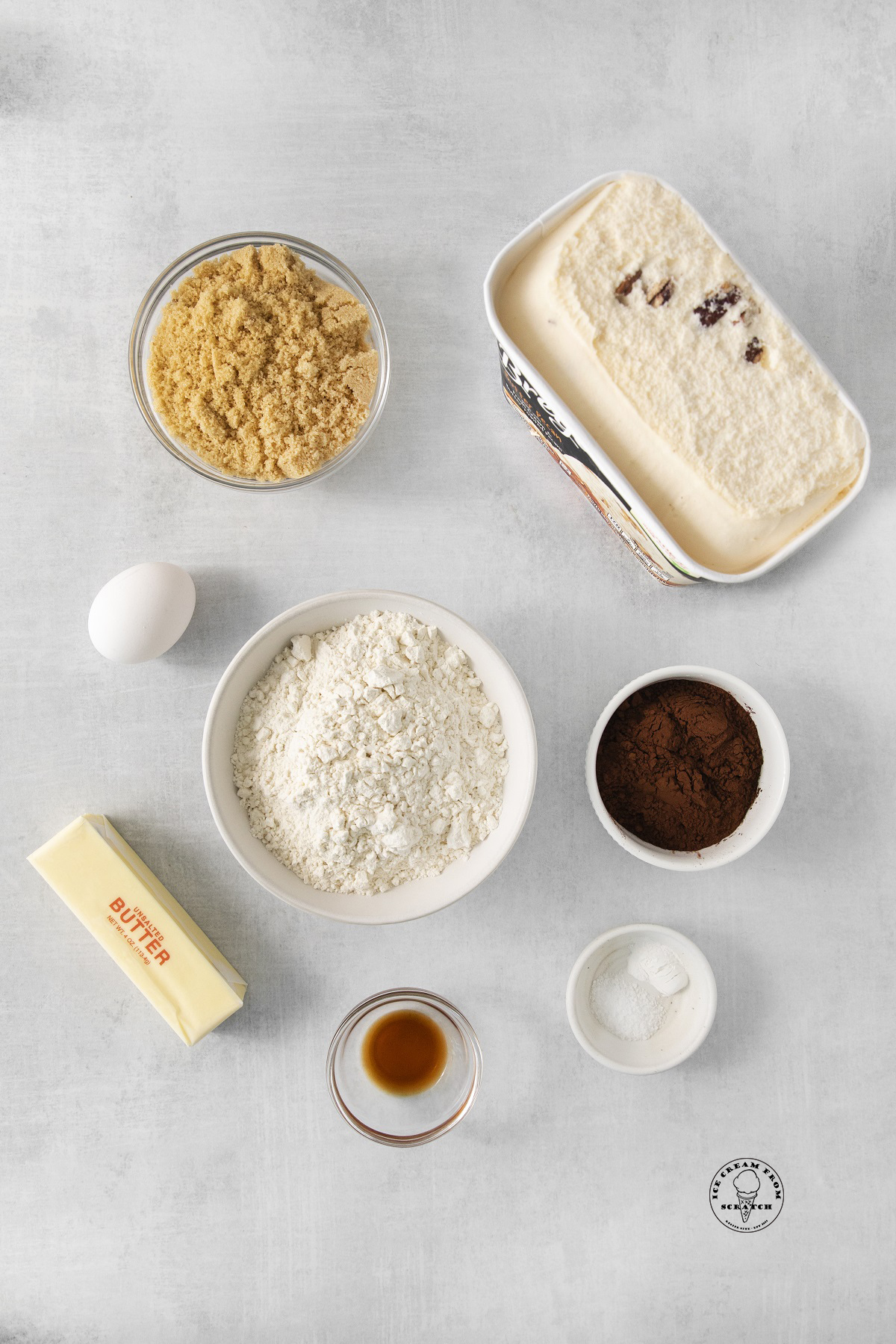 A tub of butter pecan ice cream, plus the ingredients needed to make ice cream sandwiches.
