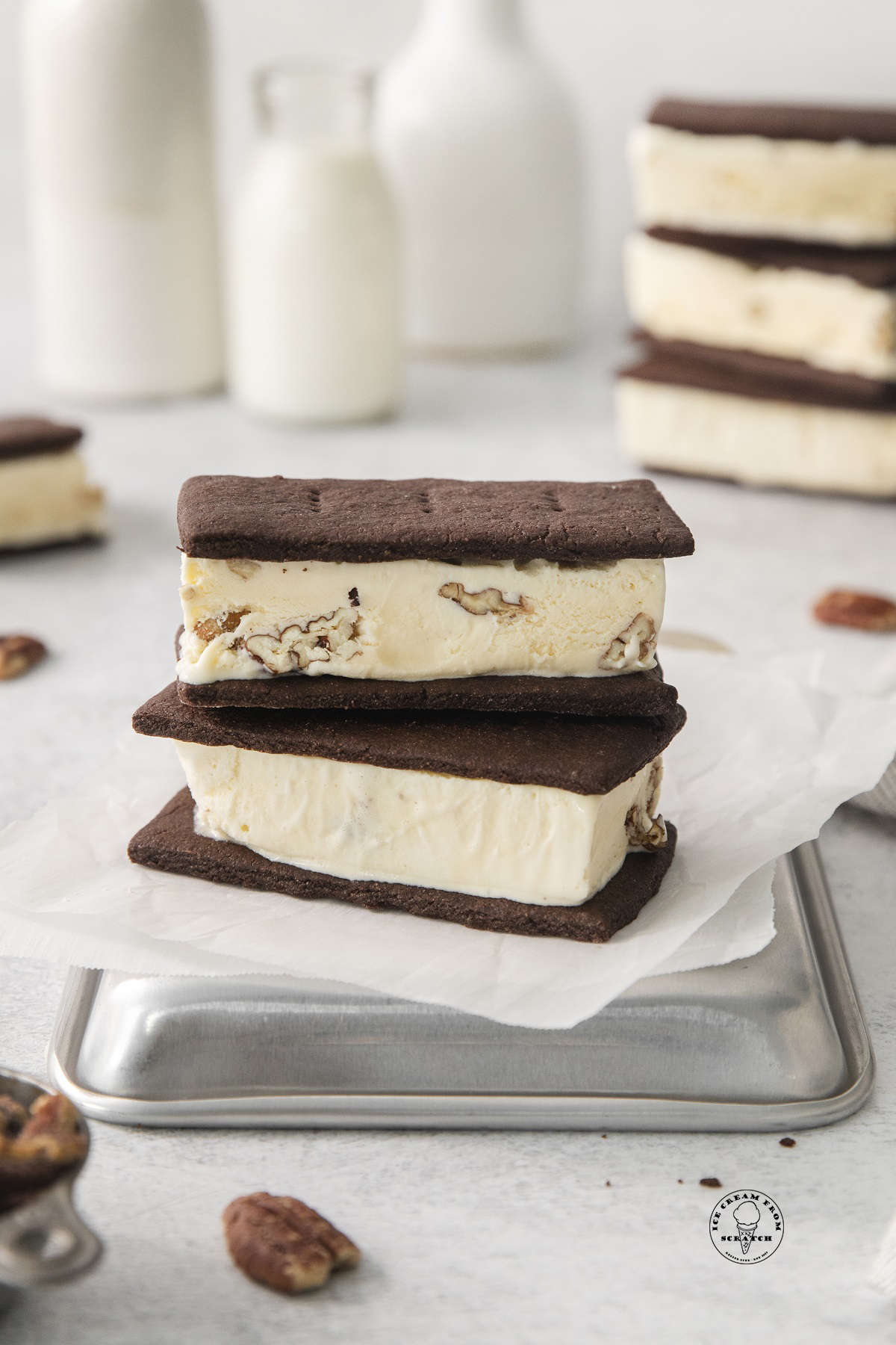 two butter pecan ice cream sandwiches on top of a sheet pan.