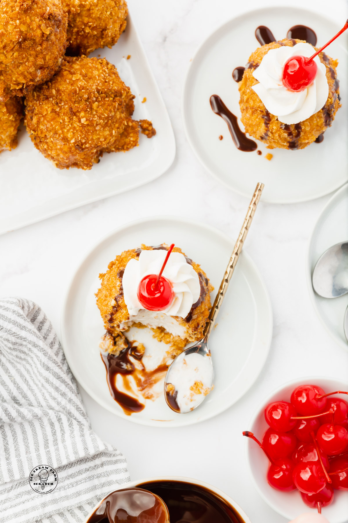 To plates of Mexican ice cream topped with whipped cream and cherries.