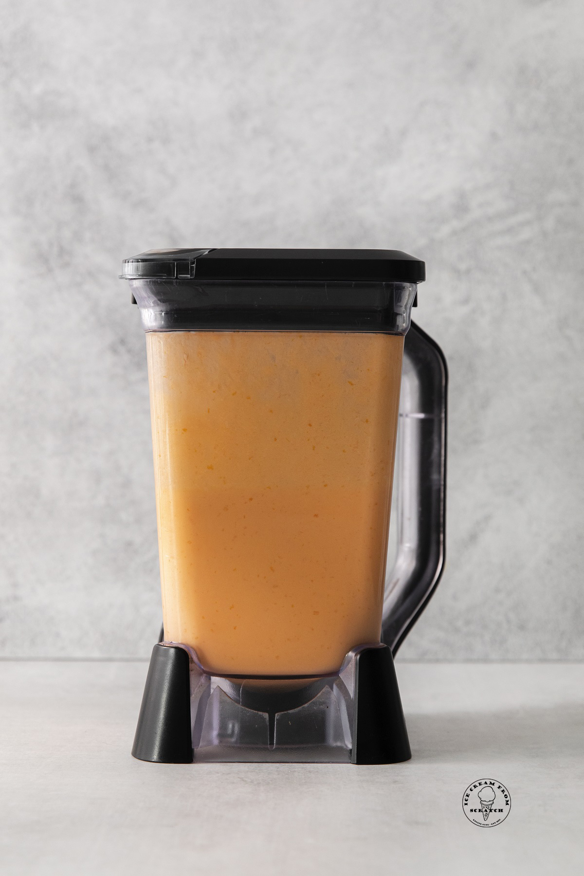 the base mixture for orange sherbet ice cream in a blender.
