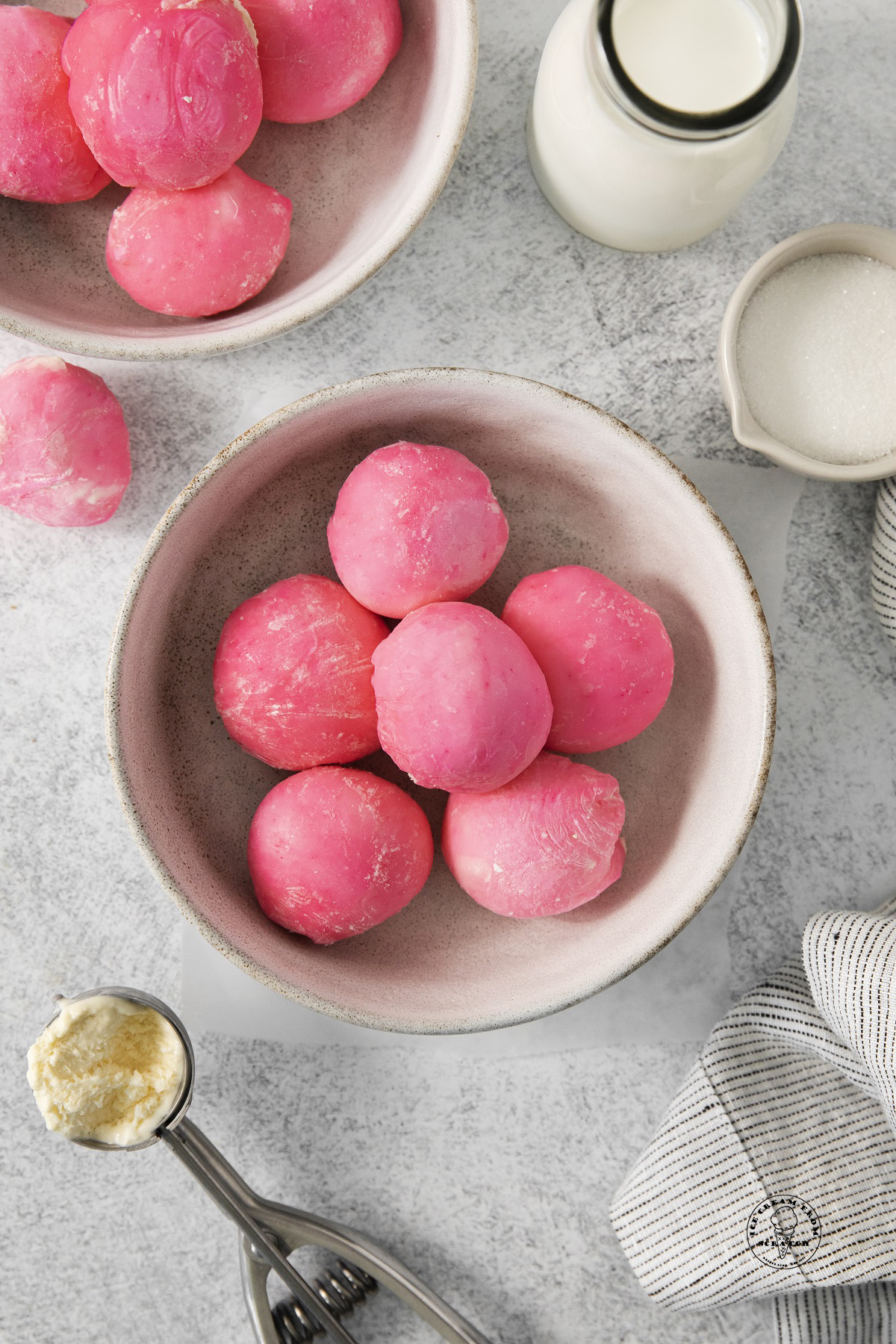 a bowl full of homemade pink mochi ice cream scoops