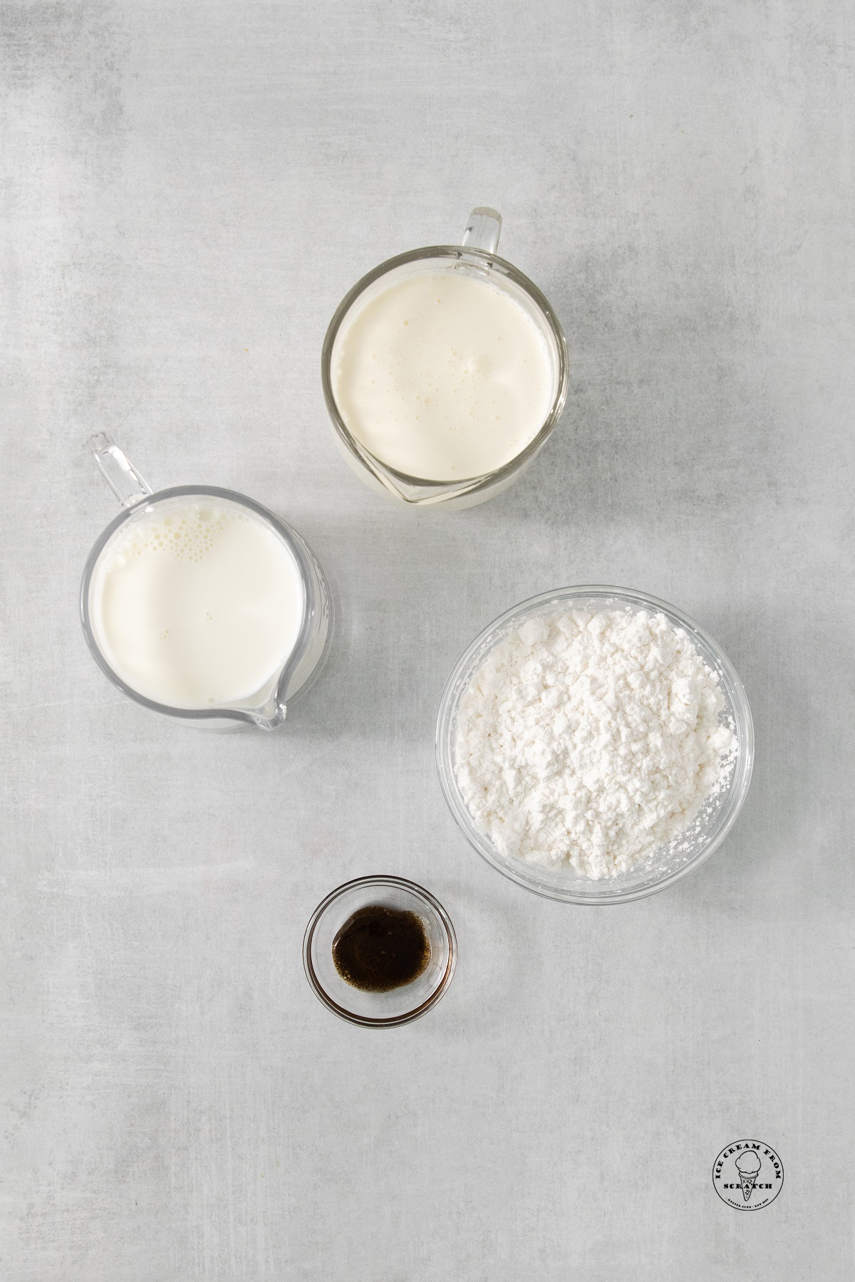 separate bowls of swerve sugar substitute, whole milk, heavy cream and vanilla extract.