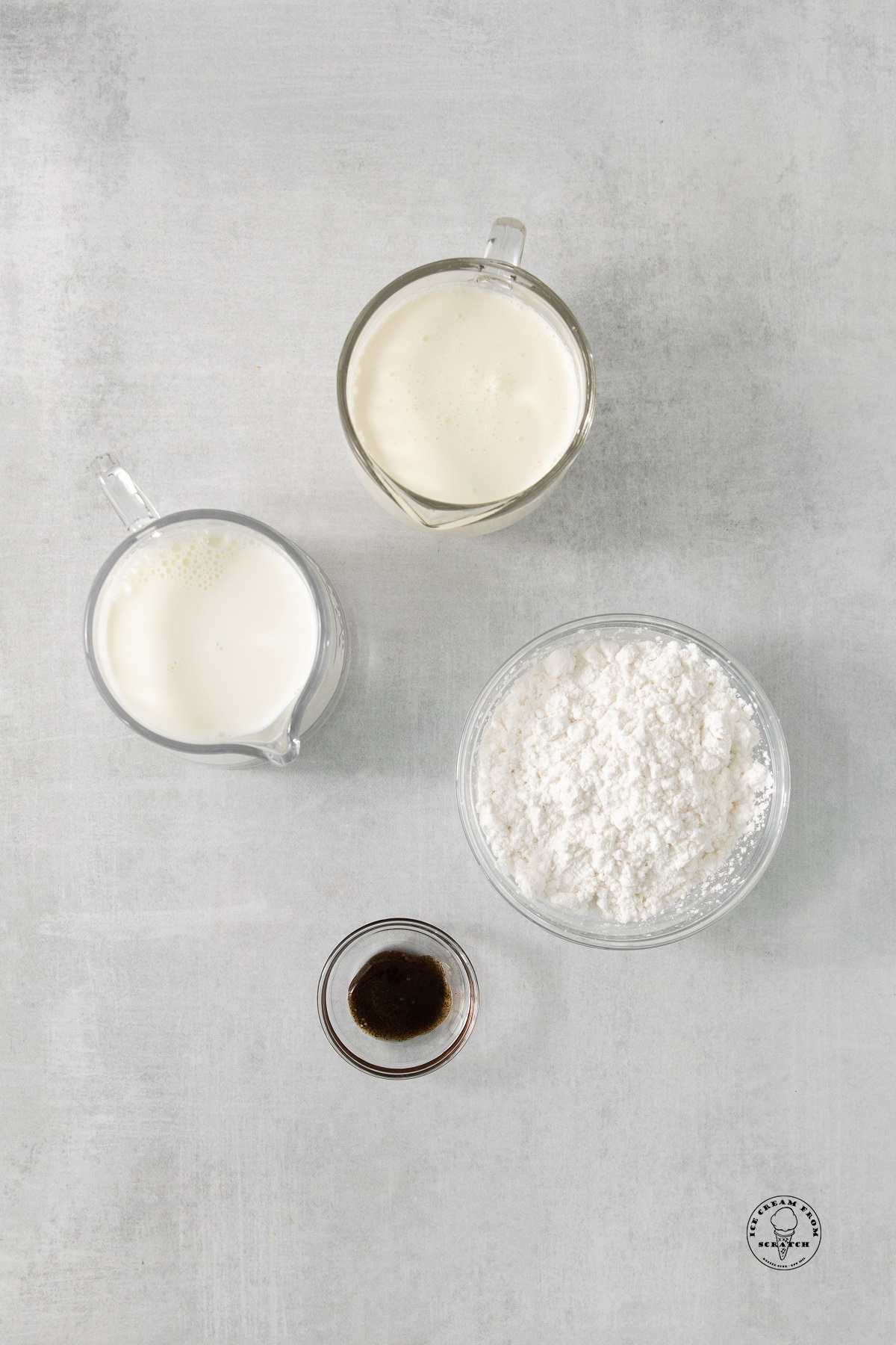 separate bowls of swerve sugar substitute, whole milk, heavy cream, and vanilla extract.