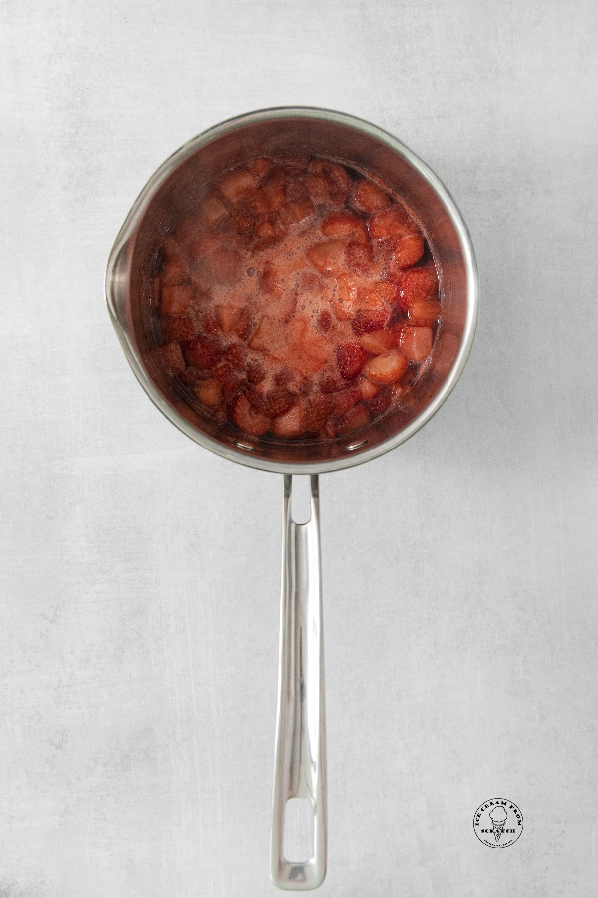a saucepan of cooked strawberries. 