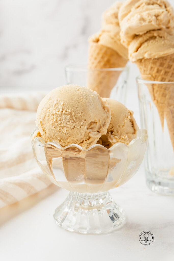 a footed glass bowl of homemade caramel ice cream