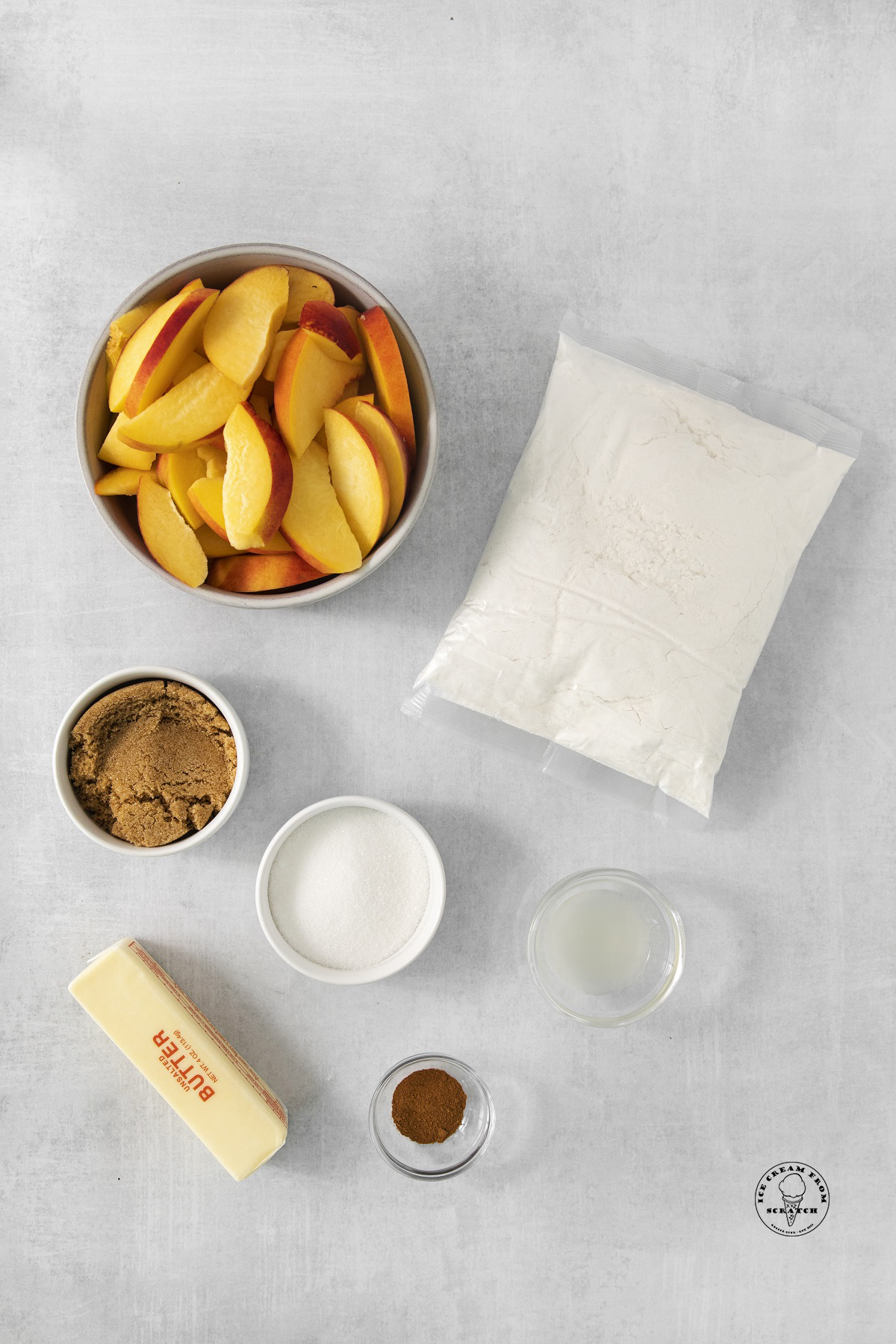 The ingredients needed to make crockpot peach cobbler with fresh peaches, cake mix, butter, and sugar.