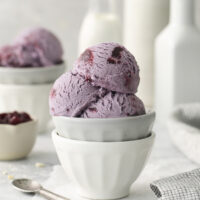 purple grape ice cream scooped into a ceramic bowl.