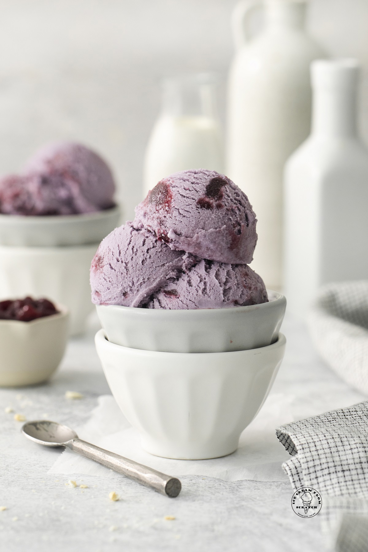 purple grape ice cream scooped into a ceramic bowl.