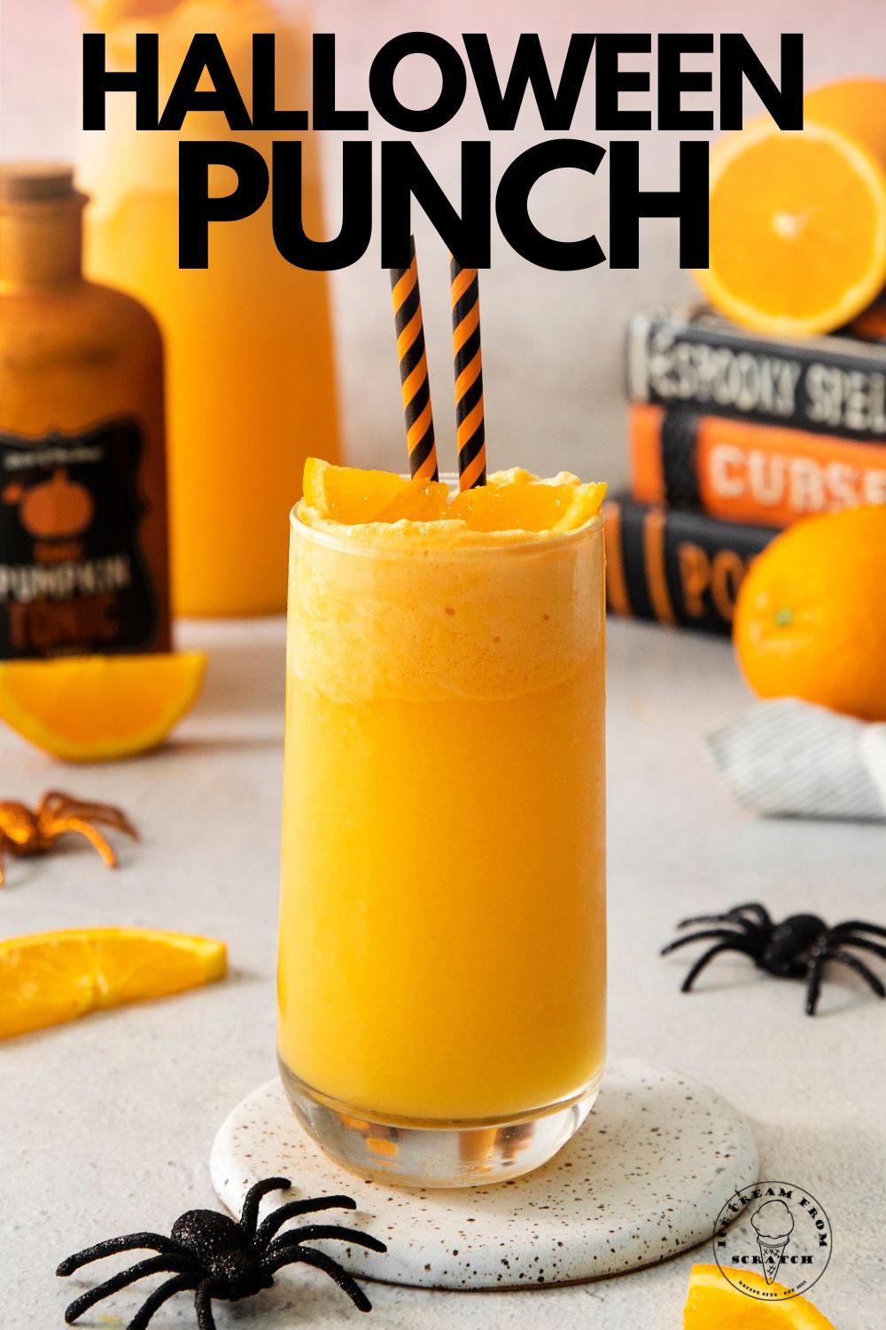 a tall glass filled with orange punch topped with orange sherbet and an orange slice. Text overlay says "halloween punch"