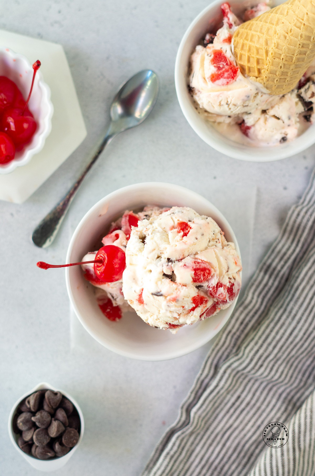a bowl of cherry cordial ice cream topped with a maraschino cherry.
