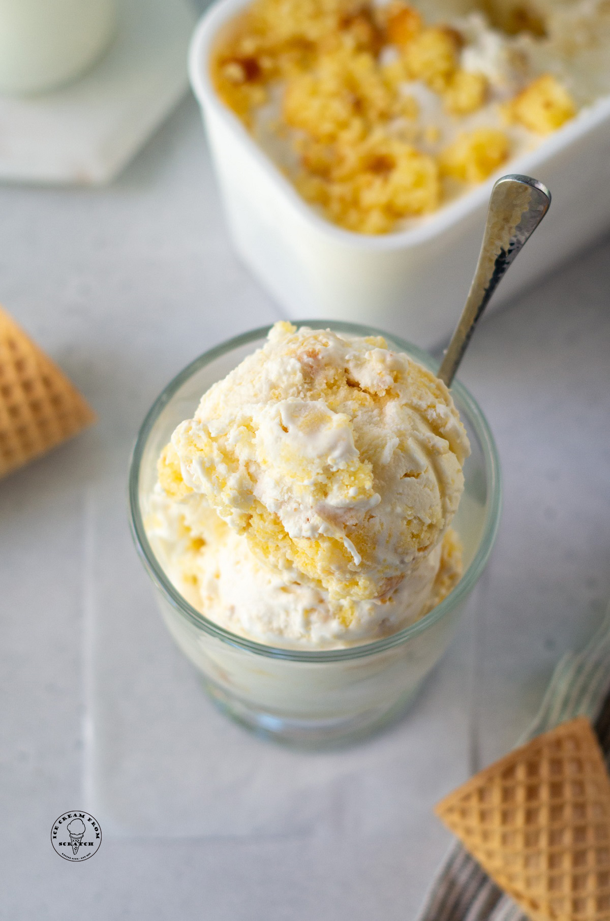 homemade cornbread ice cream in a glass dish with a spoon.