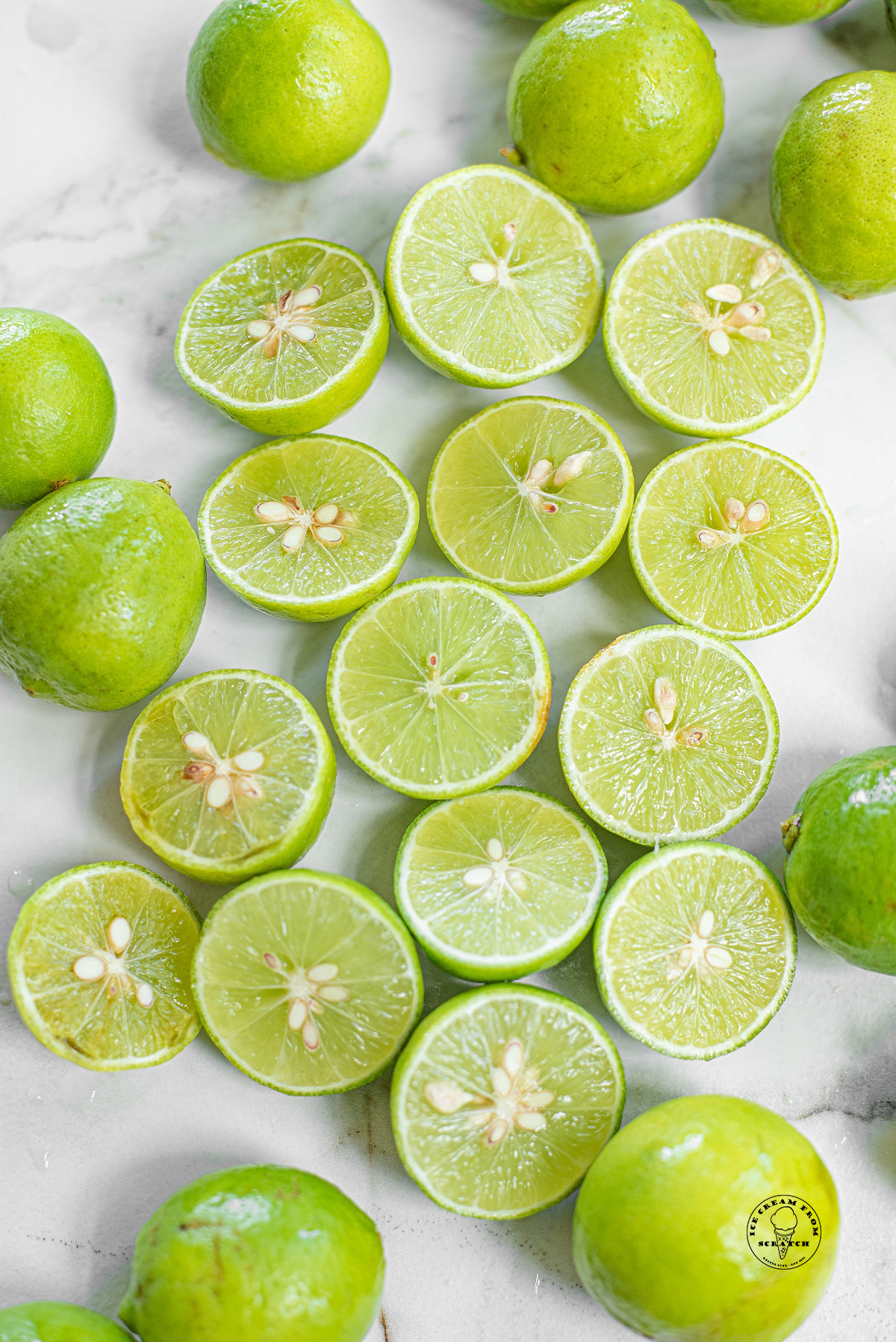 limes, cut in half, spread out on a marble counter
